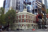 The red brick Oxford Scholar pub on Swanston Street sits in front of an RMIT University building.
