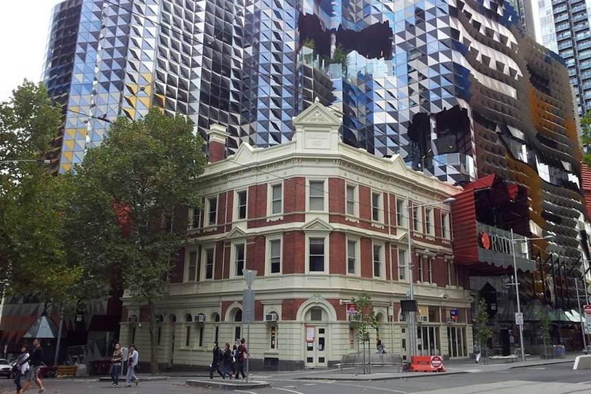 The red brick Oxford Scholar pub on Swanston Street sits in front of an RMIT University building.