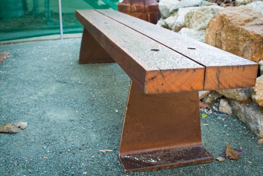 A wooden bench made entirely for recycled products.