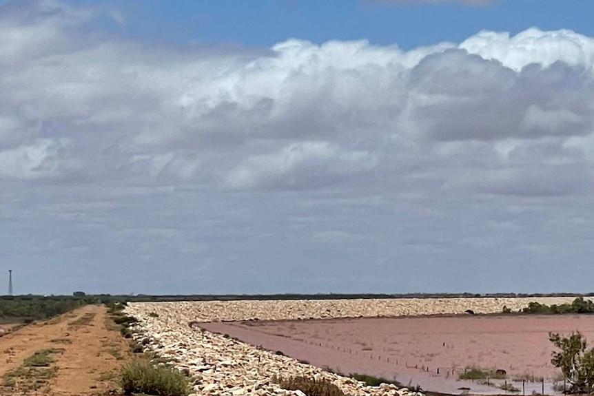 Flood levy with cloud sky in background.