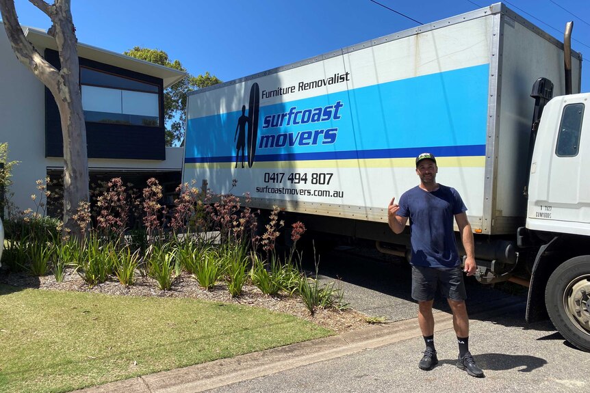 a man standing in front of a removalist truck