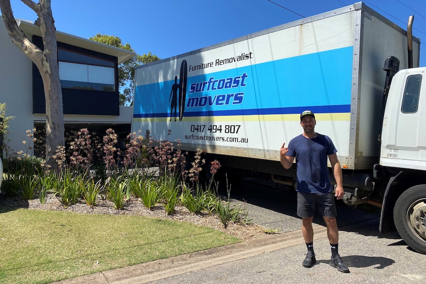 a man standing in front of a removalist truck