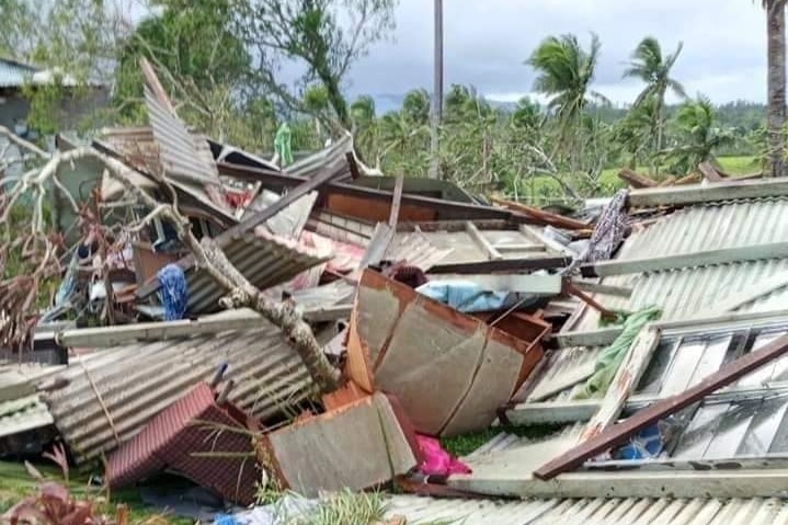 A corrugated iron home is flattened by a cyclone.