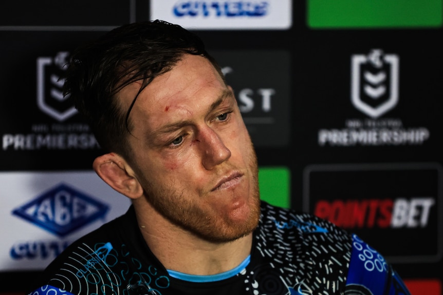 NRL player Cam McInnes sitting during a press conference, looking frustrated, after a loss
