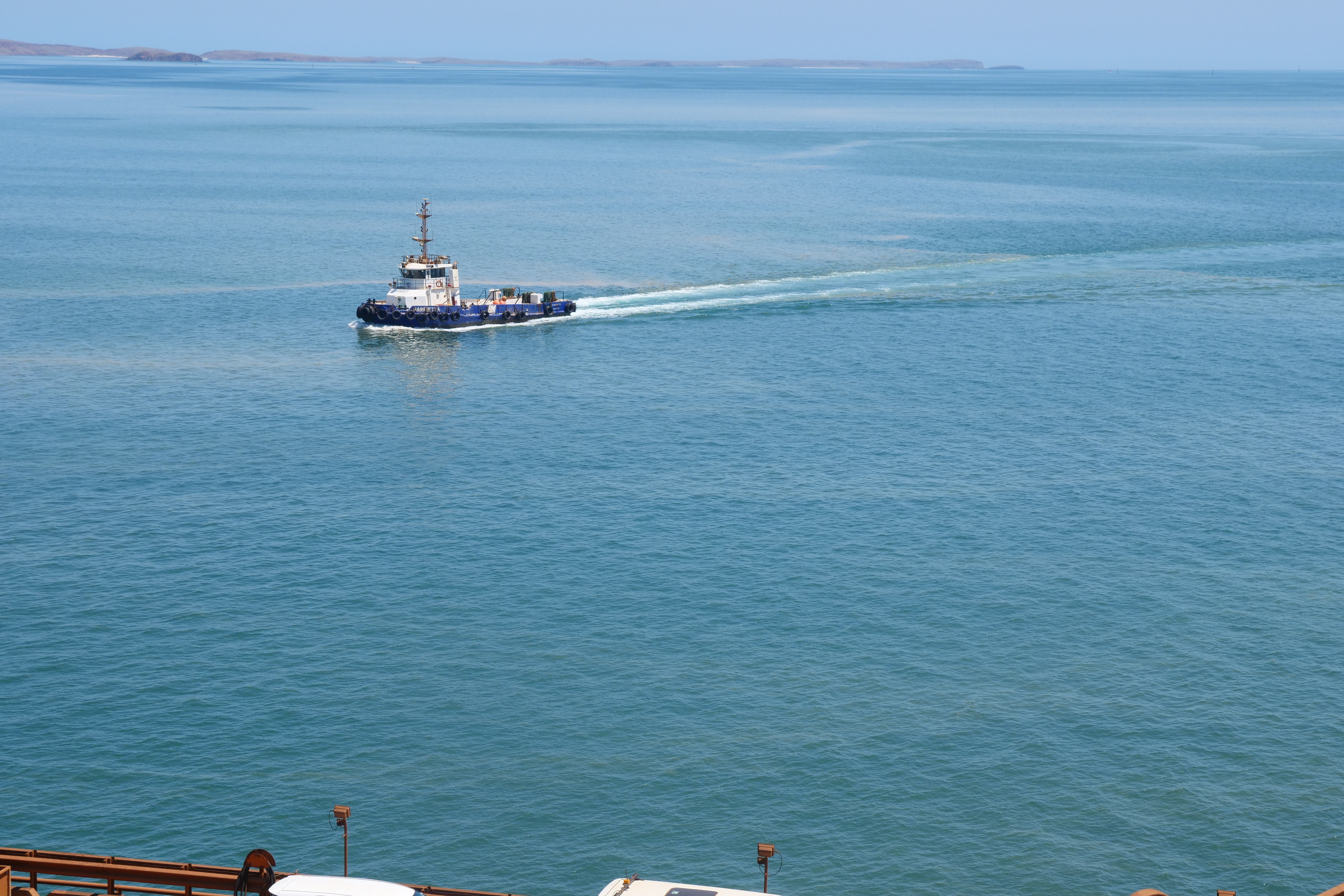 A tugboat on a still blue sea