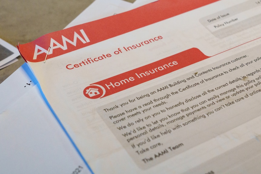 A close up photo fo a document from AAMI home insurance on a kitchen bench
