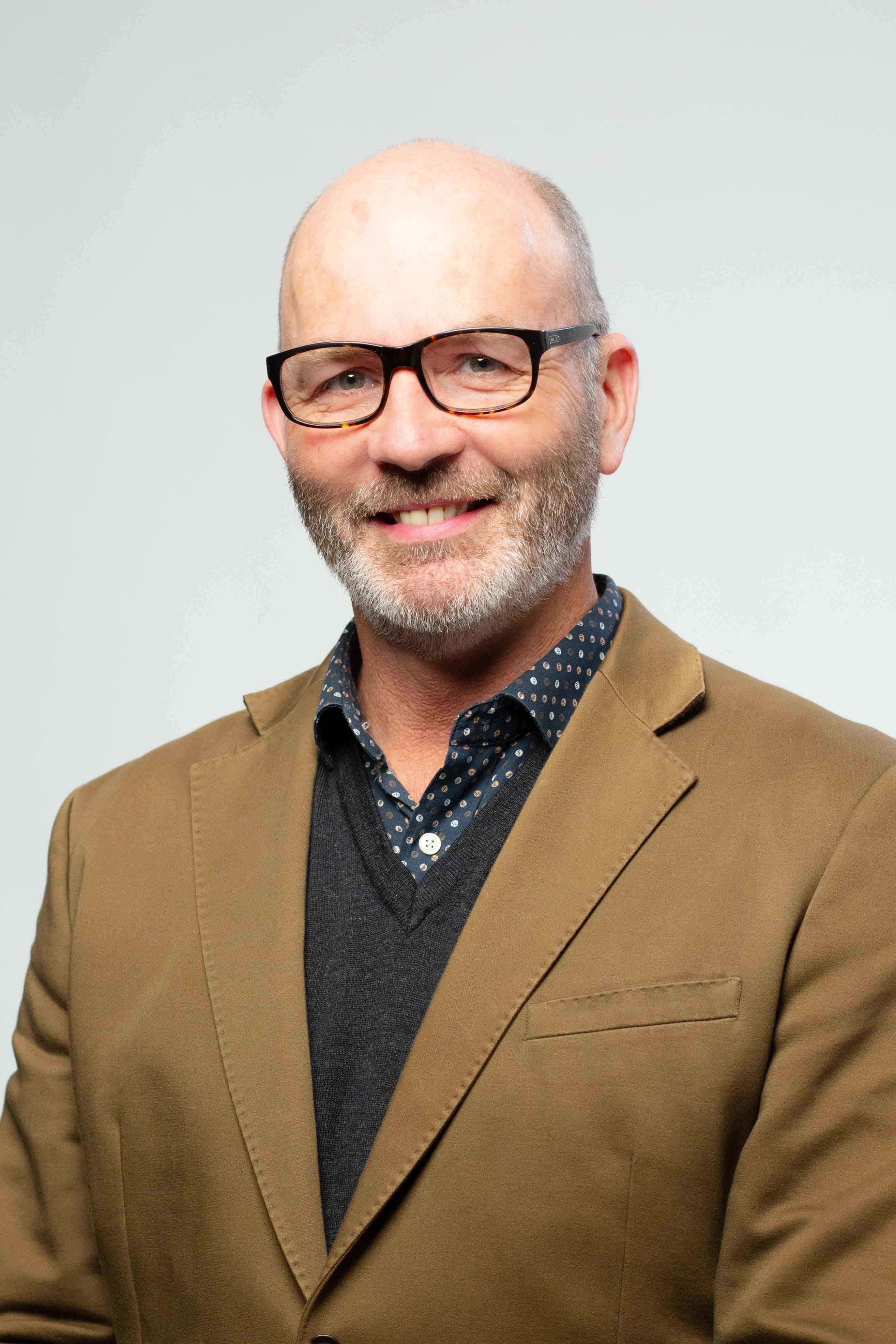 A man wearing a brown jacket
