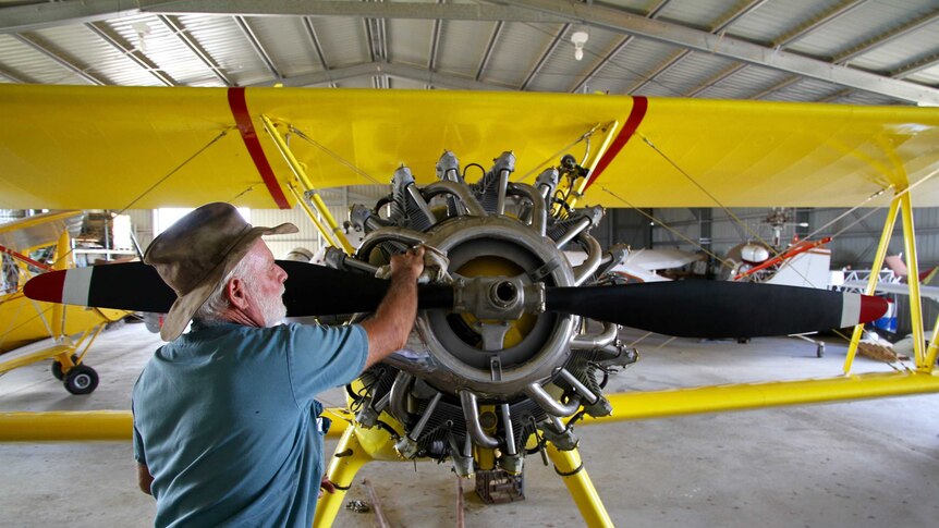 Ross Smith cleans restored plane in Rolleston workshop, April 2016.