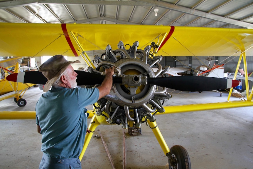 Ross Smith cleans restored plane in Rolleston workshop, April 2016.