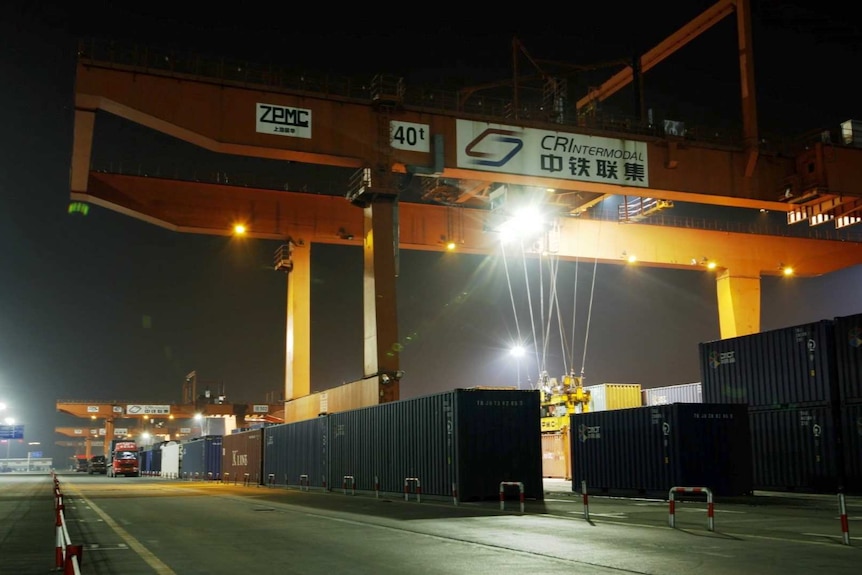 A crane attached to a shipping container in the Chongqing logistics centre, southern China.