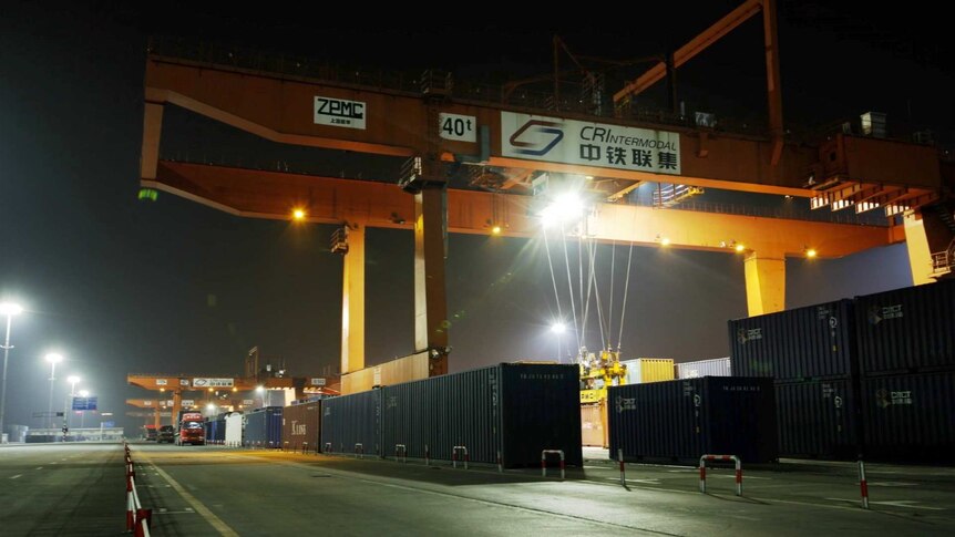 A crane attached to a shipping container in the Chongqing logistics centre, southern China.
