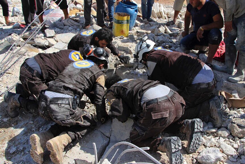 Civil dense workers searching in the rubble after airstrikes hit in the northern province of Idlib.