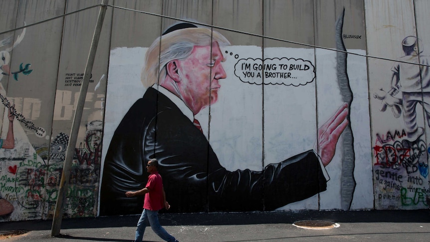 A mural of Donald Trump wearing a Jewish skullcap on Israel's West Bank separation barrier.