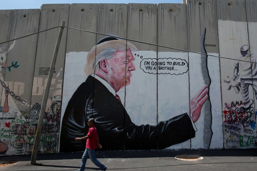 A mural of Donald Trump wearing a Jewish skullcap on Israel's West Bank separation barrier.