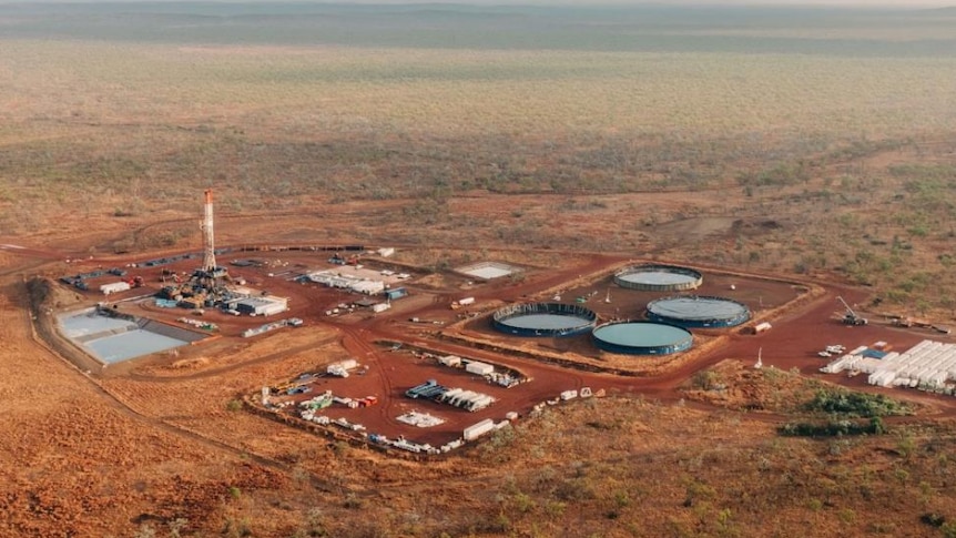 A photo of a gas exploration project. The image is taken by a drone and shows a busy mine.