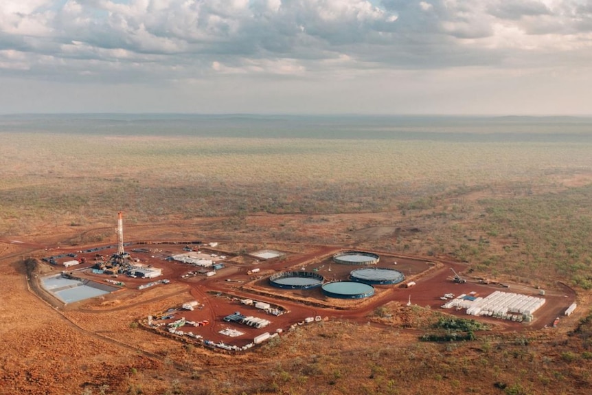 A photo of a gas exploration project. The image is taken by a drone and shows a busy mine.
