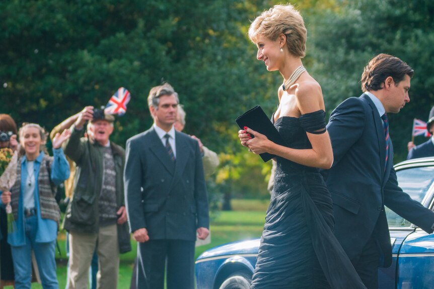 Debicki wears Diana's off-the-shoulder black dress, which has been dubbed "the revenge dress."