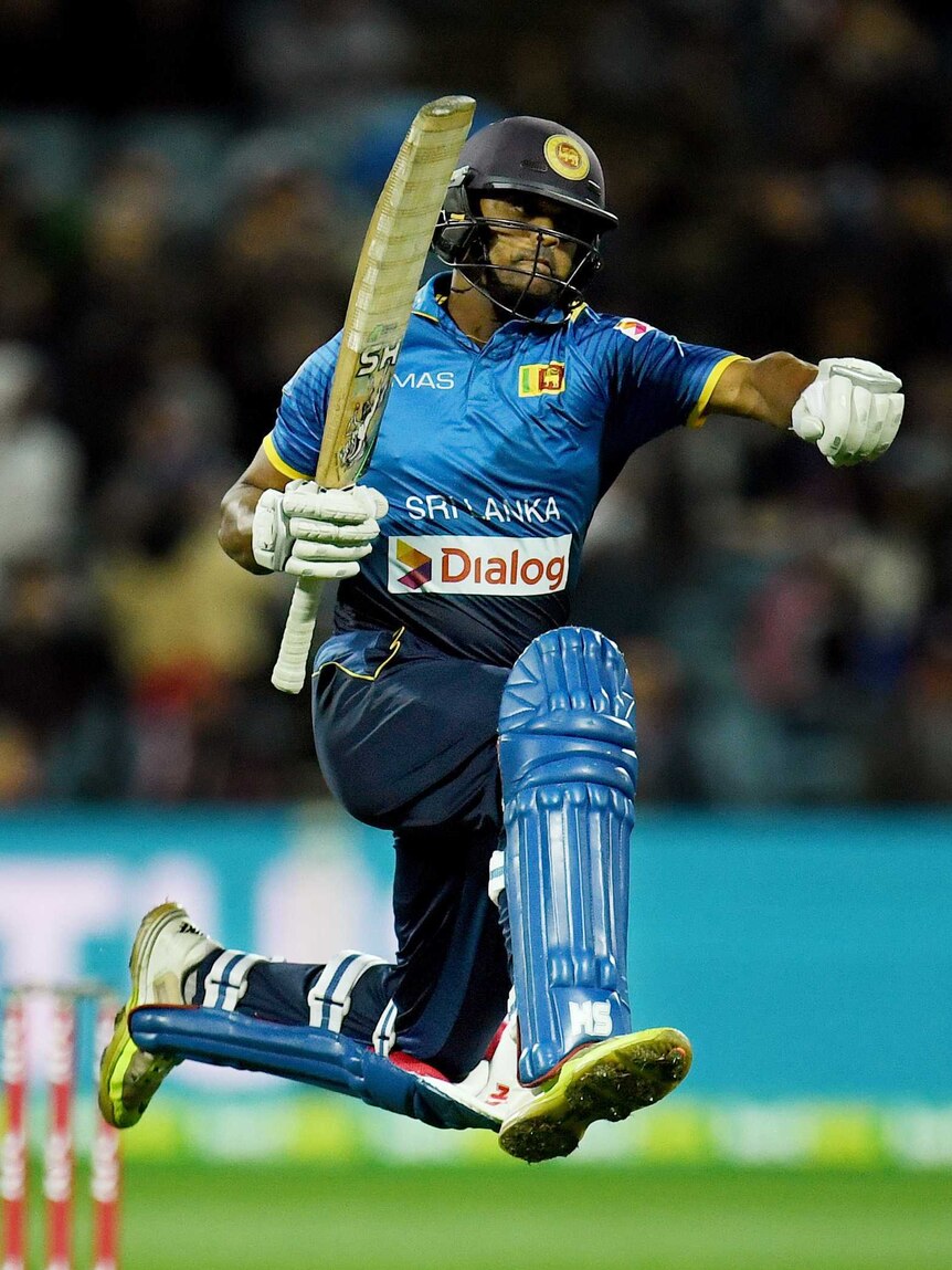 Asela Gunaratne of Sri Lanka jumps after hitting a four and winning the T20 International series.