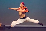 Kyran Hymers in an 'Aladdin' type custom dancing on stage.