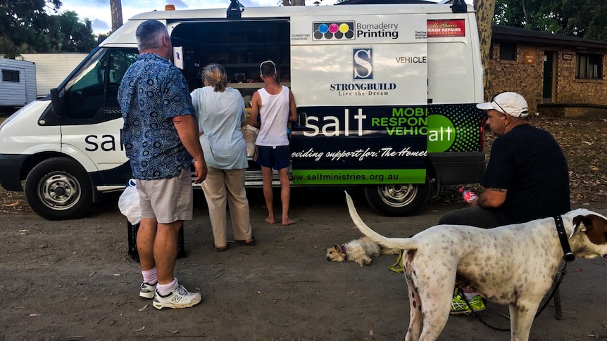 People line up for food outside a Salt Ministries van at the Nowra showgrounds.