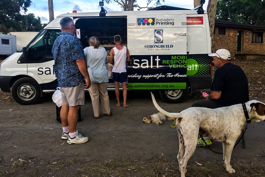 People line up for food outside a Salt Ministries van at the Nowra showgrounds.