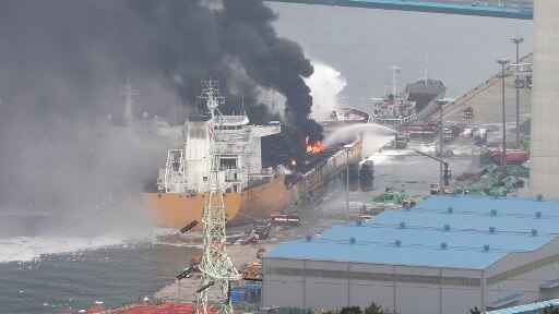 Fire crews spray water onto a fire on a deck of an oil tanker in South Korea.