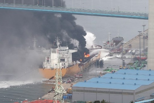 Fire crews spray water onto a fire on a deck of an oil tanker in South Korea.