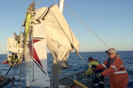 A piece of plane wreckage being lifted onto a rescue boat off Barwon Heads.