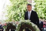 PM Jens Stoltenberg lays a reef during commemorations for the Utoya massacre and Norway bombing