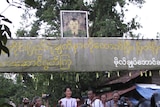 Call for unity: Aung San Suu Kyi greets supporters outside her home