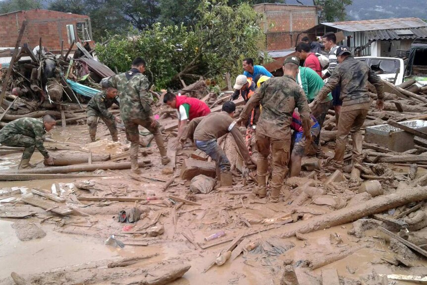 soldiers and residents work together to clean up after the landslide