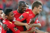 On target ... The Reds swarm on Dario Vidosic (R) after he scored against the Sky Blues