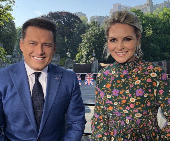 A smiling picture in a UK street with Stefanovic in a blue suit and Gardner in a floral dress.