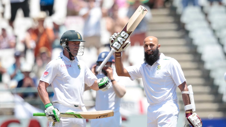 South African captain Hashim Amla (R) raises his bat for a Test century against England at Newlands
