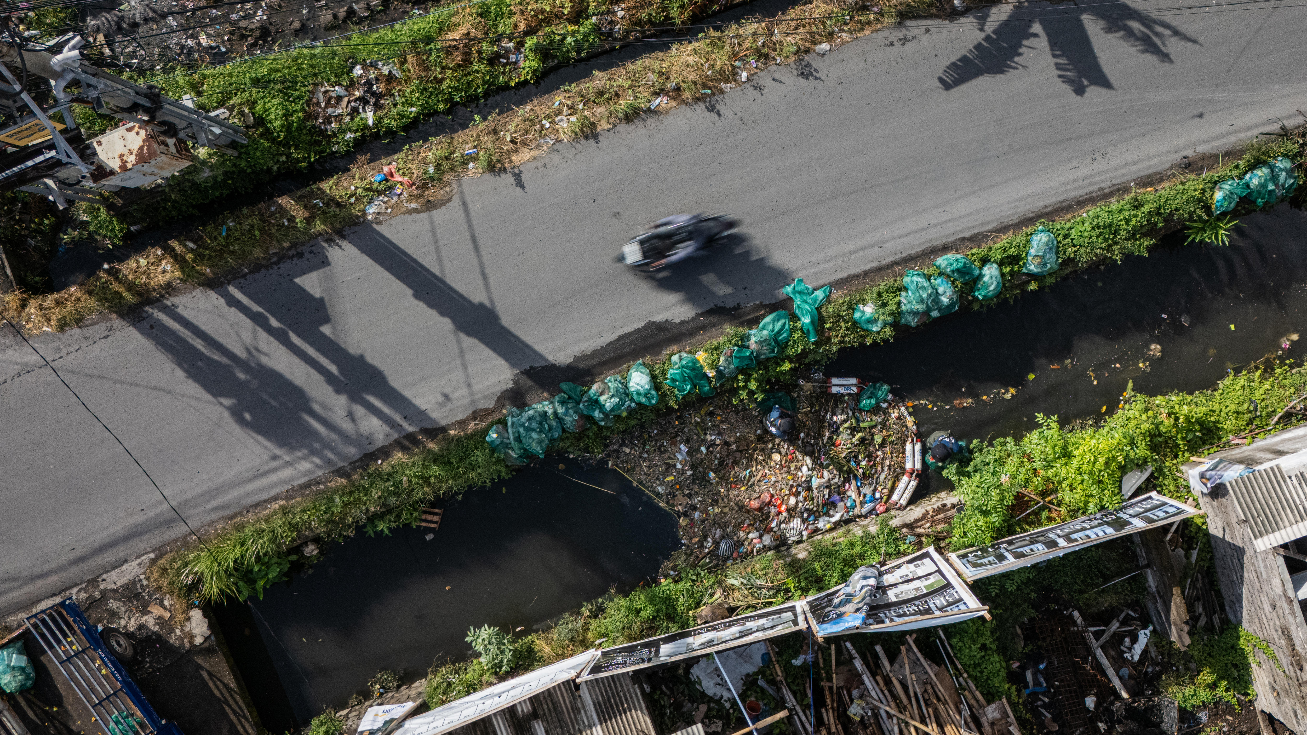 A birdseye view of trash piled up in a waterway in Bali's Denpasar.