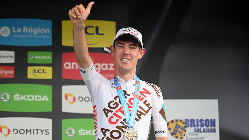 Australian cyclist Ben O'Connor of AG2R Citröen Team gives a thumbs up on the the podium after the Criterium du Dauphine 2022.
