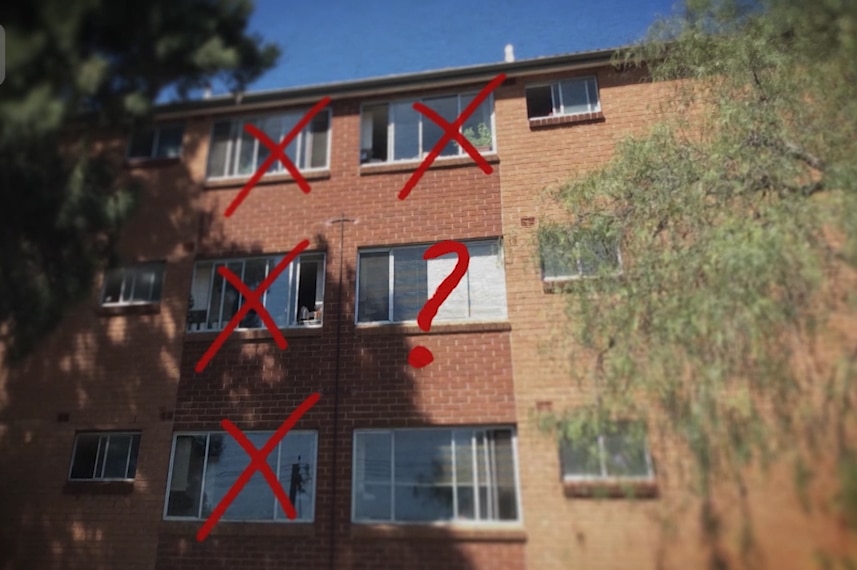 Apartment block with red crosses over apartments and a question mark over one