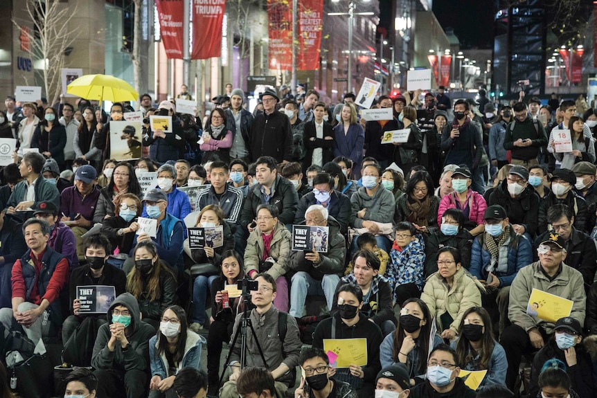 Hundreds of pro-Hong Kong protesters sit in Martin Place.