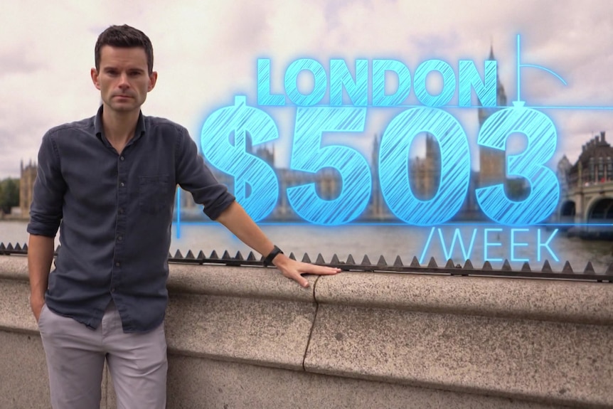 reporter nick dole next to a sign that reads London