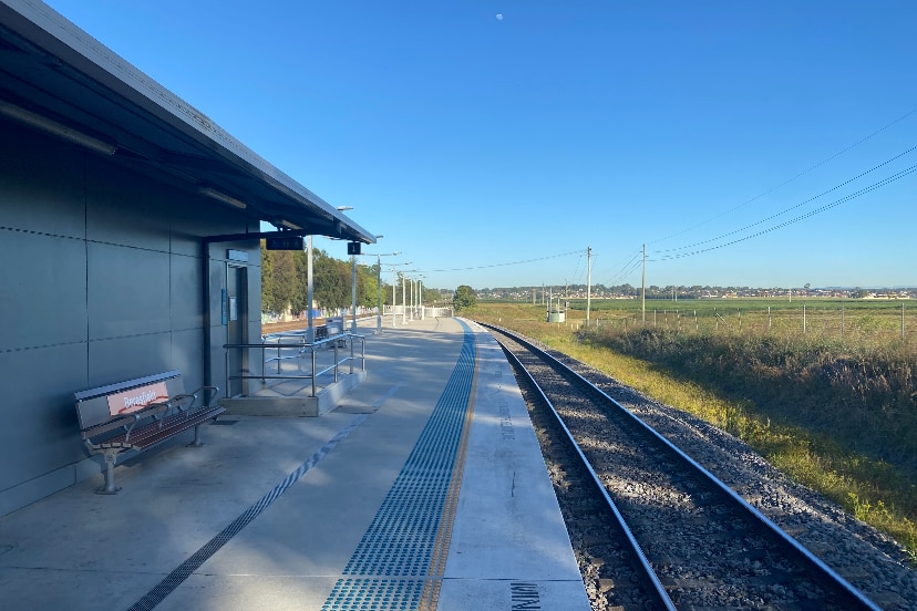 A wide shot from a train station platform