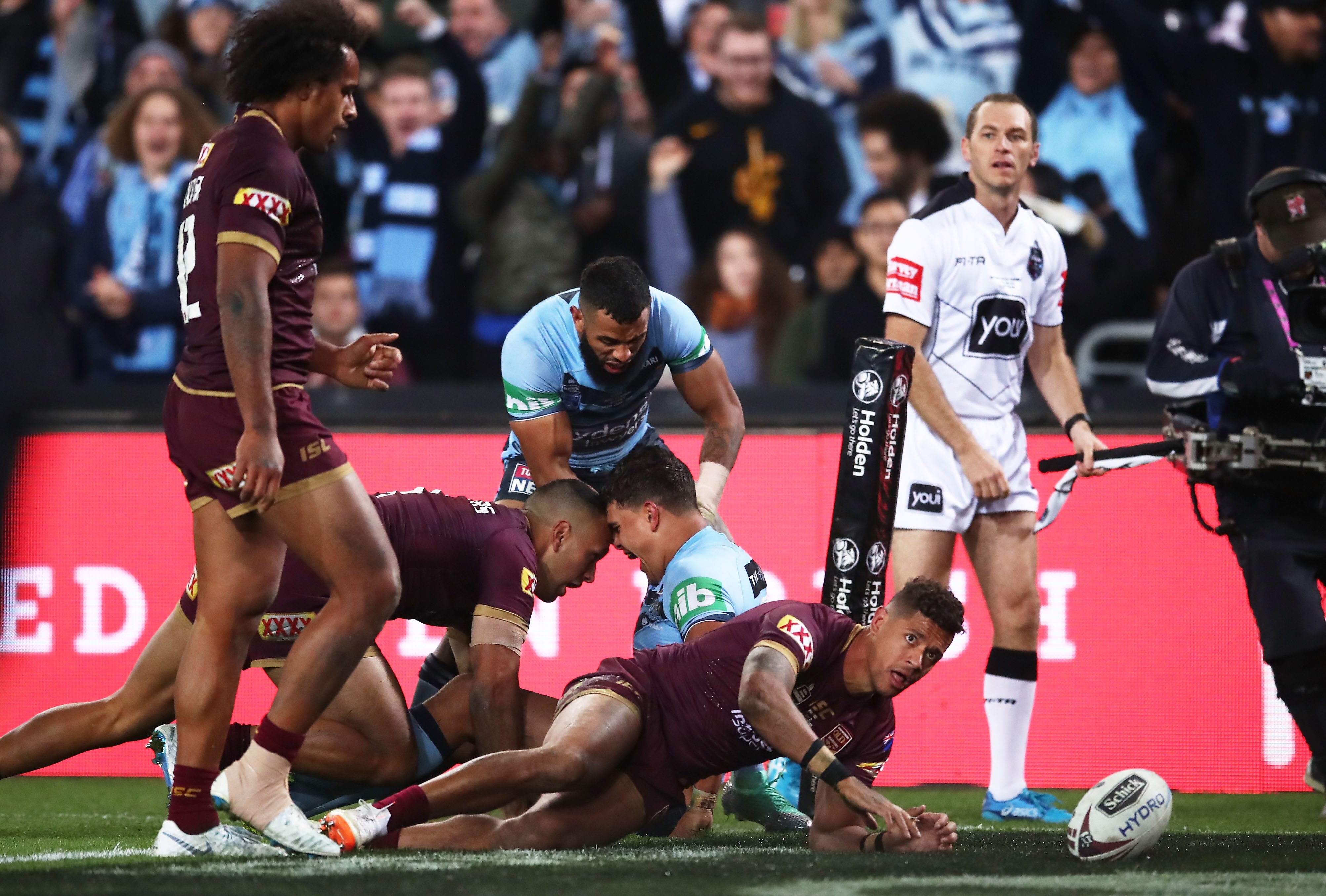 A man celebrates after scoring a try in an Origin match