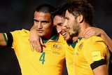 Cahill, Milligan and Leckie celebrate a goal against Tajikistan