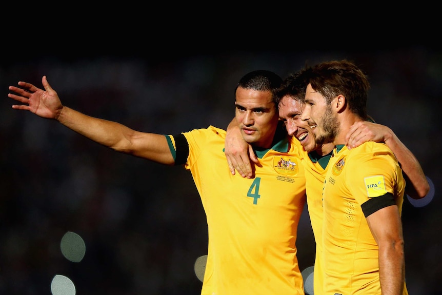 Tim Cahill, Mark Milligan and Mat Leckie celebrate a goal against Tajikistan