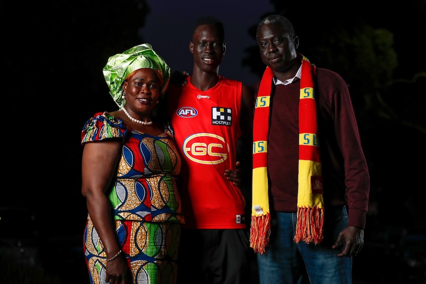 Mac Andrew with his parents, Mary and Lual.