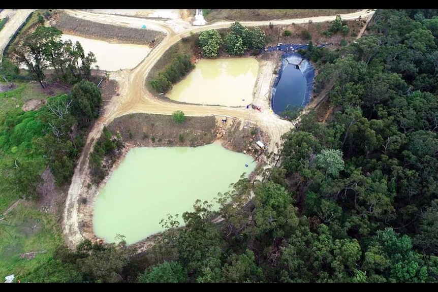 An aerial view of two large ponds, part of a massive landfill site at Mangrove Mountain on the  NSW Central Coast.