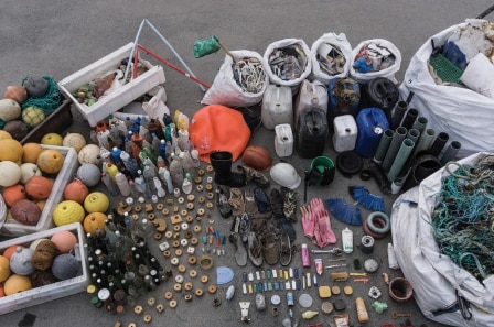 Sort bags of marine rubbish such as nets, bottles and boyes.