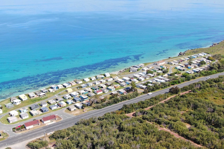 A view of a cluster of shacks sitting on the shores of Cockburn Sound