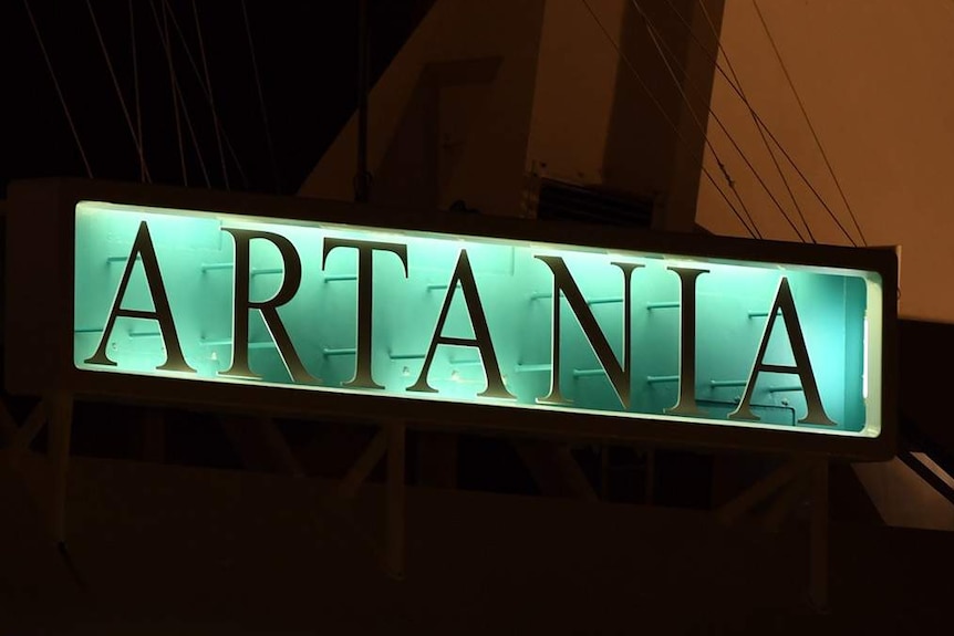 A close-up shot of the Artania sign on the cruise ship docked at Fremantle Port before dawn.
