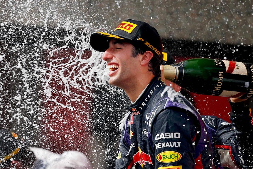 Daniel Ricciardo is sprayed with champagne by team-mate Sebastian Vettel.