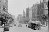 A black and white streetscape of Collins St, Melbourne 